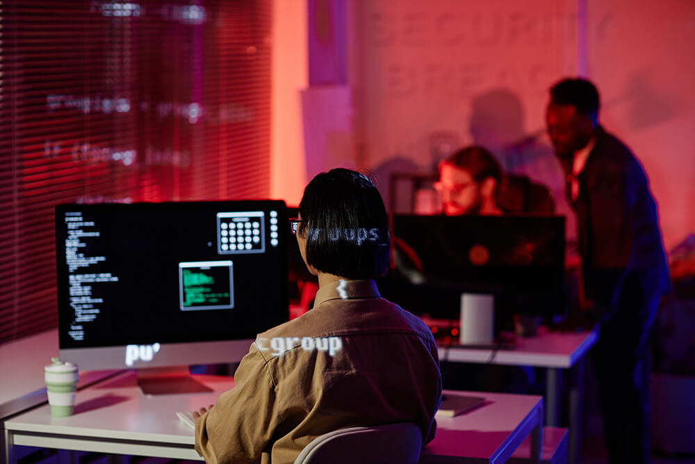 rear-view-young-contemporary-programmer-sitting-front-computer-screen