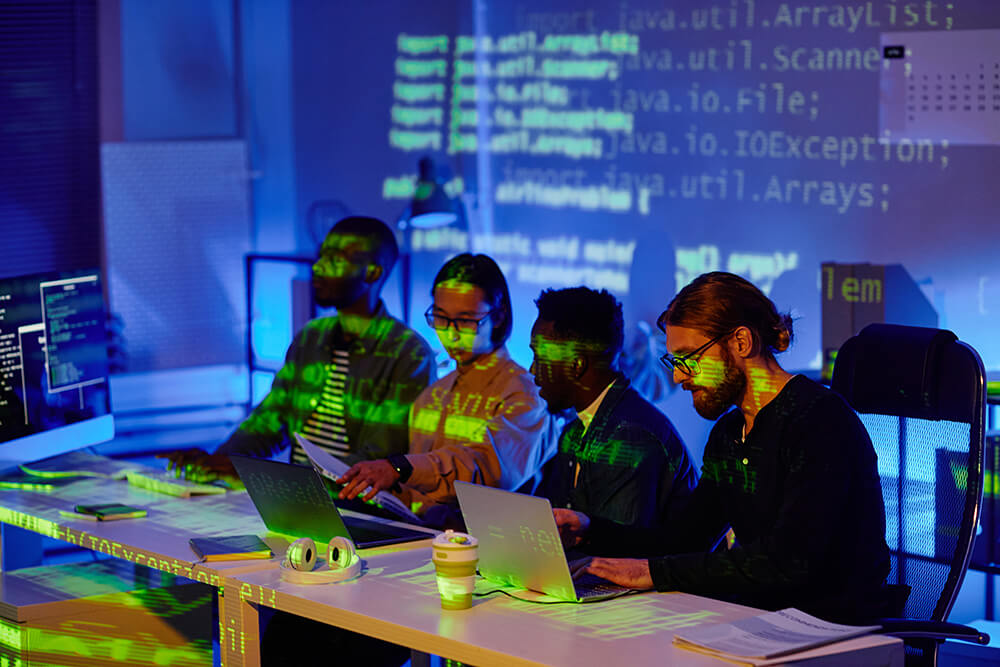 several-young-contemporary-software-developers-sitting-row-by-desks-during-presentation-new-programming-language